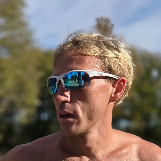 Matthew Brunken, smiling, in running gear outdoors